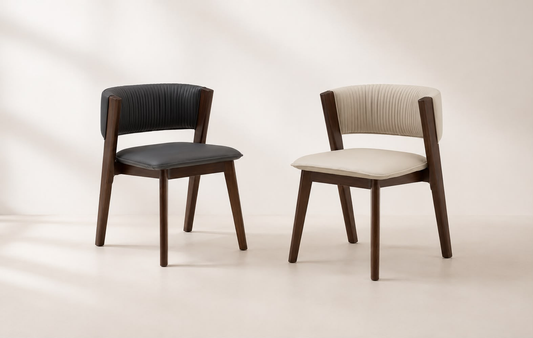 Two modern dining chairs with dark wood frames, shown side by side against a warm off-white background. The left chair has a black ribbed upholstered backrest and seat, while the right chair has a cream ribbed upholstered backrest and seat.